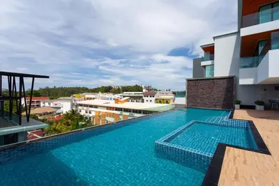 a swimming pool on the roof of a building at 1 bed Corner apartment in Kata - Grand Kata VIP in Kata Beach
