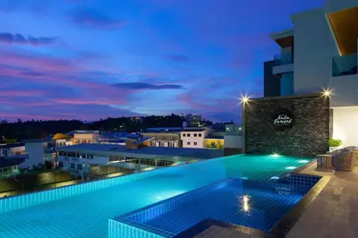 a pool on the roof of a building at night at 1 bed Corner apartment in Kata - Grand Kata VIP in Kata Beach