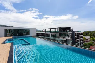 a swimming pool on the roof of a building at 1 bed Corner apartment in Kata - Grand Kata VIP in Kata Beach