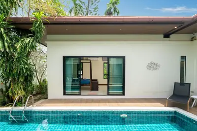 a swimming pool in front of a house at Rawai - 3 BR Private Pool Villa - Phoomjai Villa in Rawai Beach