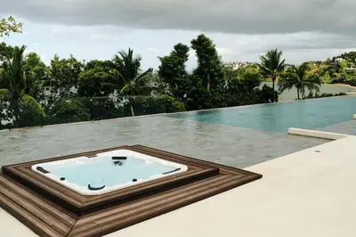 a pool with a hot tub on the roof of a house at Villa Arun in Phuket Town