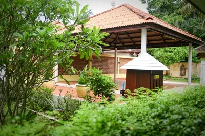 a house with a bird house in a garden at Shimmer Three-Bedroom Villa with large garden and two swimming pools in Rawai Beach