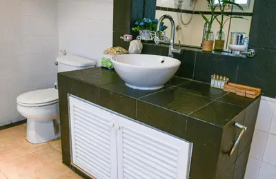 a bathroom with a sink and a toilet at Shimmer Three-Bedroom Villa with large garden and two swimming pools in Rawai Beach