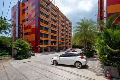 a white car parked in front of a building at New Condo NaiHarn Beach by Capital Pro in Phuket Town