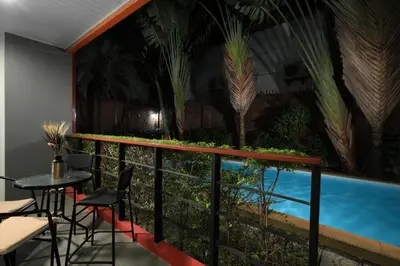 a balcony with a swimming pool and a table and chairs at 1bdr Pool Access Studio on NaiHarn Beach by Capital Pro in Phuket Town