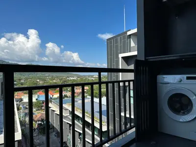 a balcony with a washing machine in a building at 1bdr Apartment Relife Naiharn by Capital Pro in Phuket Town
