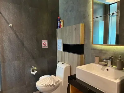 a bathroom with a white toilet and a sink at 1bdr Apartment Relife Naiharn by Capital Pro in Phuket Town
