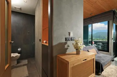 a bathroom with a bed and a toilet in a room at 1bdr Apartment ReLife Windy Naiharn by CapitalPro in Phuket Town