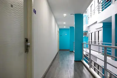 a hallway of a hospital with blue and white walls at iCheck inn Chill Patong in Patong Beach