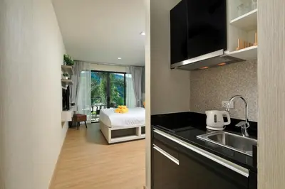 a kitchen with a sink and a bed in a room at 1bdr Apartment on the Kata Beach SPL-101 by Capital Pro in Phuket Town