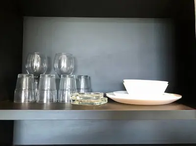 a shelf with glasses and a plate and a bowl at Kamala Beach P53 Exclusive Junior Suite in Kamala Beach