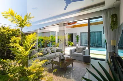 a living room with a couch and a table at Villa Mimosa 2, Splendid 3 Bedroom Master Ensuite in Phuket Town