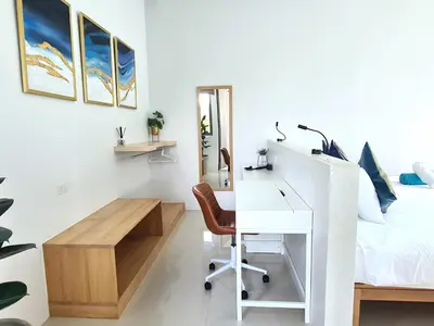 a white bedroom with a desk and a bed at Villa Mimosa 2, Splendid 3 Bedroom Master Ensuite in Phuket Town