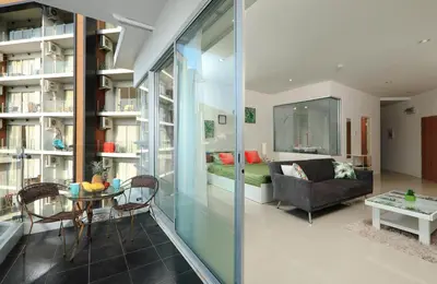 a living room with a couch and a table at 1bdr Apartment with bath in Chic Condo By Capital Pro in Phuket Town