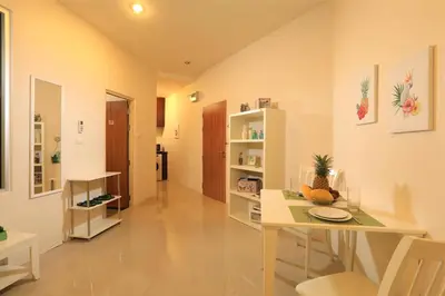 a living room with a table and a dining room at 1bdr Apartment with bath in Chic Condo By Capital Pro in Phuket Town