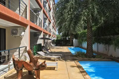 a resort with a swimming pool next to a building at New apartment Rawai Beach 310 by Capital Pro in Phuket Town