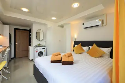 a bedroom with a large bed with two towels at New apartment Rawai Beach 218 by Capital Pro in Phuket Town