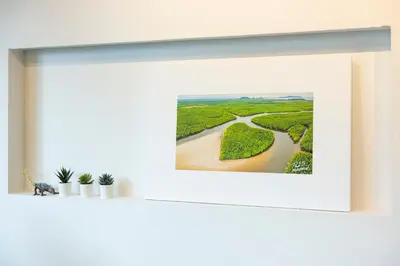 a picture frame on a shelf with a river at Chamemon Bed Phuket Town in Phuket Town