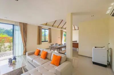 a living room with a white couch and orange pillows at 3bdr VIP Villa Rawai with private pool in Phuket Town