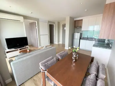 a living room with a table and a couch at Mountain view apartment in the heart of BangTao in Bang Tao Beach