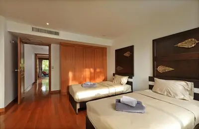 a hotel room with two beds and a hallway at 2bdr Townhouse in Laguna Village by Capital Pro in Phuket Town
