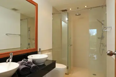 a bathroom with a sink and a glass shower at 2bdr Townhouse in Laguna Village by Capital Pro in Phuket Town