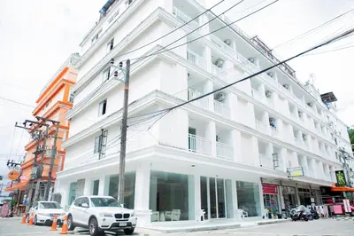 a white building on the corner of a street at Blue Skyline Hotel in Patong Beach