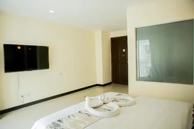 a room with two swans on a bed with a large screen at Blue Skyline Hotel in Patong Beach