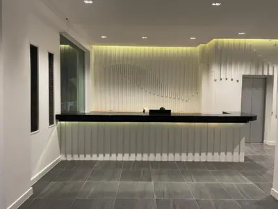 a lobby with a reception desk and a large window at Blue Skyline Hotel in Patong Beach