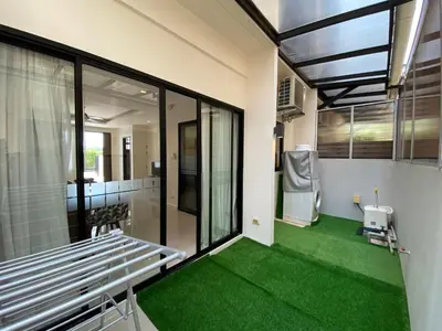 a room with a green floor and a bench at 2 bdr Townhouse in Laguna Park by CapitalPro in Phuket Town
