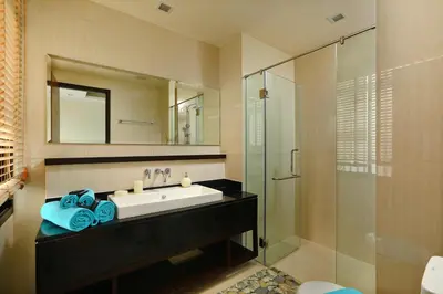 a bathroom with a sink and a glass shower at 3bdr Townhouse Laguna Park Bangtao Beach by CapitalPro in Phuket Town