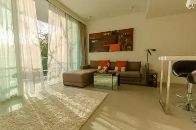 a living room with a couch and a table at 2bdr Apartment Oceanstone Laguna by Capital Pro in Phuket Town