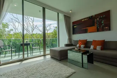 a living room with a couch and a table at 2bdr Apartment Oceanstone Laguna by Capital Pro in Phuket Town
