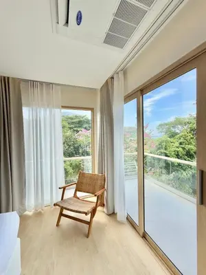 a room with a chair and a large window at Ton Sai Tropical Phi Phi Island in Phi Phi Don