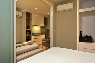 a bedroom with a bed and a living room at 1bdr Cozy apartment in Diamond Resort Bangtao Beach by Capital Pro in Phuket Town