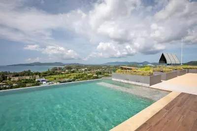 a swimming pool on the roof of a house with a view at 2 bdr Apartment in Mida Grande Surin Beach by CapitalPro in Phuket Town