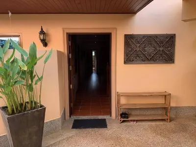 a hallway of a house with a plant in a pot at Villa Malee , Sea View Infinity Pool, Staff, Chef in Kata Beach