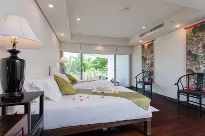 a bedroom with a large white bed with a large window at Katamanda - Villa Katamalee Private Pool near Kata Noi Beach in Kata Beach