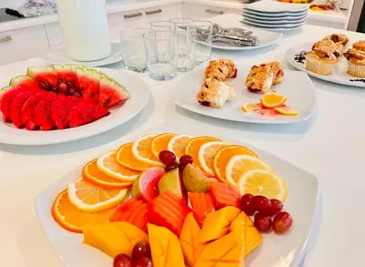 a white table with plates of fruit on it at Katamanda - Villa Katamalee Private Pool near Kata Noi Beach in Kata Beach