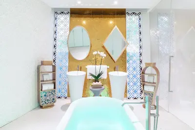 a bathroom with two sinks and a mirror at Iniala Beach House in Natai Beach