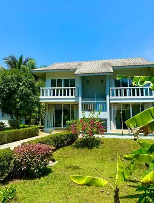 a large blue house with a yard at Peaceful Retreat Villa by Nai Thon beach in Phuket Town