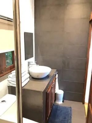 a bathroom with a white sink and a mirror at 1 bedroom Villa on Ao Yon beach with sea views in Phuket Town