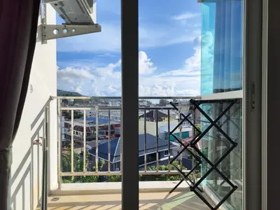 an open balcony with a view of the ocean at 7 Floor - Ozone Condotel near Kata beach by 15 minutes walking in Kata Beach