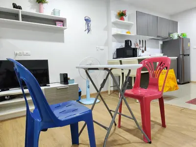 two colorful chairs and a table in a kitchen at 7 Floor - Ozone Condotel near Kata beach by 15 minutes walking in Kata Beach