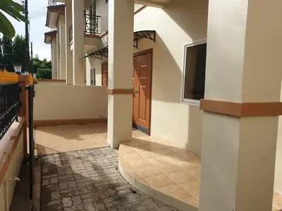 a hallway of a house with a door and a sidewalk at My Friend's House Villa in Karon Beach