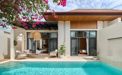 a house with a swimming pool in front of it at Onyx Villas by TropicLook in Nai Harn Beach