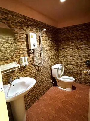 a bathroom with a toilet and a sink and a shower at View Garden Resort in Phi Phi Don