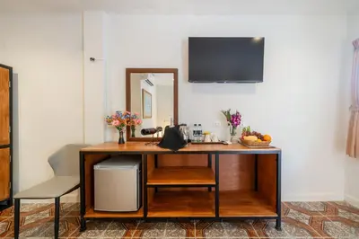 a room with a desk with a mirror and a chair at Oceanview Bungalows by EAT in Karon Beach