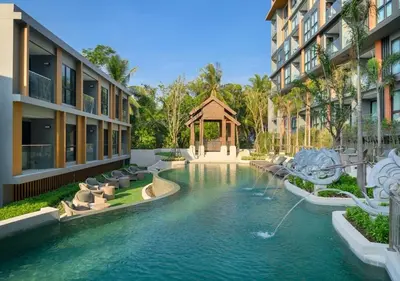 a swimming pool in the middle of two buildings at Уютные апартаменты в Mide Grant in Phuket Town