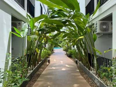 a corridor of a building with plants on both sides at Great Hill Jungle View Pool Gym Naiyang in Nai Yang Beach